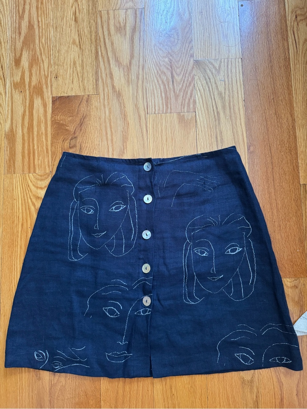 Paloma Wool - fun linen button-front mini skirt with face pattern